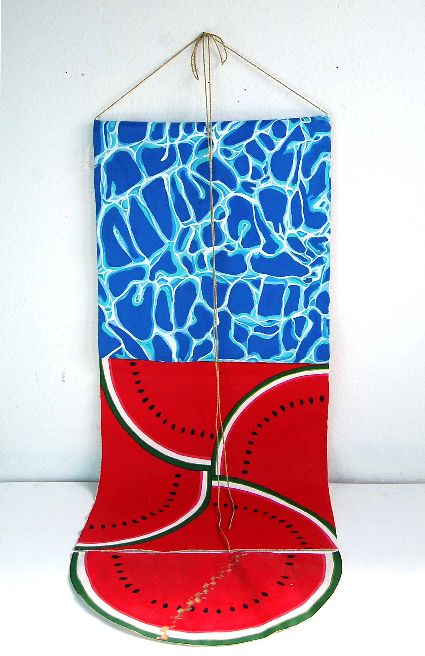 Painting of water 
            above watermellon on loose canvas that is hung lonw and spilling onto the ground.
